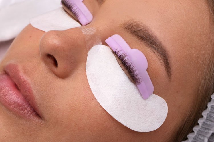 Client undergoing a lash lift procedure at a beauty salon